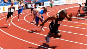 High resolution image of some sprinters starting to take the baton at athletics event.