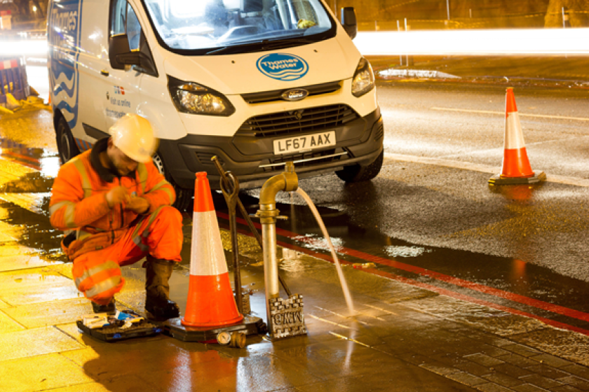 Hard hats & team of workers wear workmen's high visibility safety jackets traveling to work Thames Water logo on side of Mercedes van on UK motorway