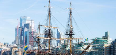 Gotheborg of Sweden, a sailing replica of the Swedish East Indiaman Gotheborg I, visiting London, UK. London city skyline, financial district