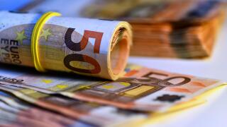 Concept of many euros: a pile of rolled 50-euro bills lying on a white background, Pile of 50 euro notes business background