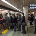 Japanese commuters boarding underground train in Tokyo, Japan