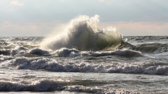 Large wave breaking on beach in New Buffalo Michigan