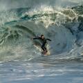 Surfers riding the huge surf created by Hurricane Marie in the Pacific Ocean at the Wedge in Newport Beach Southern California