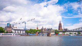 Summer panorama of the financial district with sky towers reflected on the river surface in Frankfurt am Main, Germany