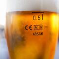 Cisal glass of full beer with CE Marking 0.5l  on table in Spain..