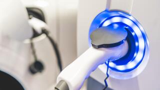 Electric Vehicle charging station system storing power on white modern car. EV fuel advanced hybrid car. automobile industry new technology concept.