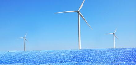 Solar panels and wind turbines in field. Concept of eco friendly thechnologies