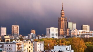Warsaw, capital city of Poland, featuring Palace of Culture and Science, Srodmiescie district. Sunset time, stormy sky.