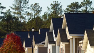 Pointed rooflines of typical middle class, southern American residential subdivision of homes that are built close together.