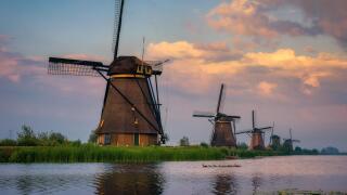 Sunset above old dutch windmills in Kinderdijk, Netherlands