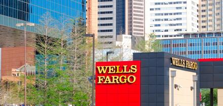 Wells Fargo branch in downtown Dallas, Texas with skyscrapers and office buildings in the background.