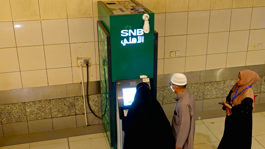 Mecca, Saudi Arabia, June 23 2024:  Pilgrims using SNB ATM to withdraw cash money, Saudi National Bank SNB AlAhli formerly The National Commercial Ban