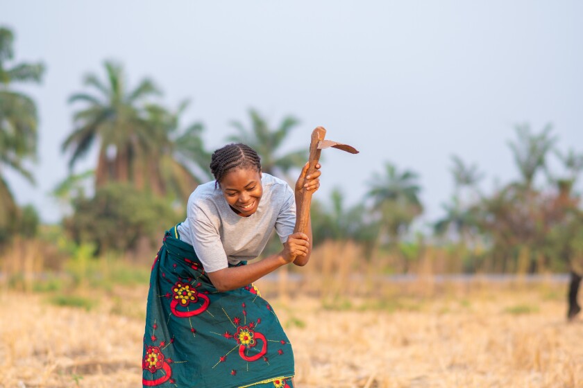 female african farmer smiling while working in her farm. african