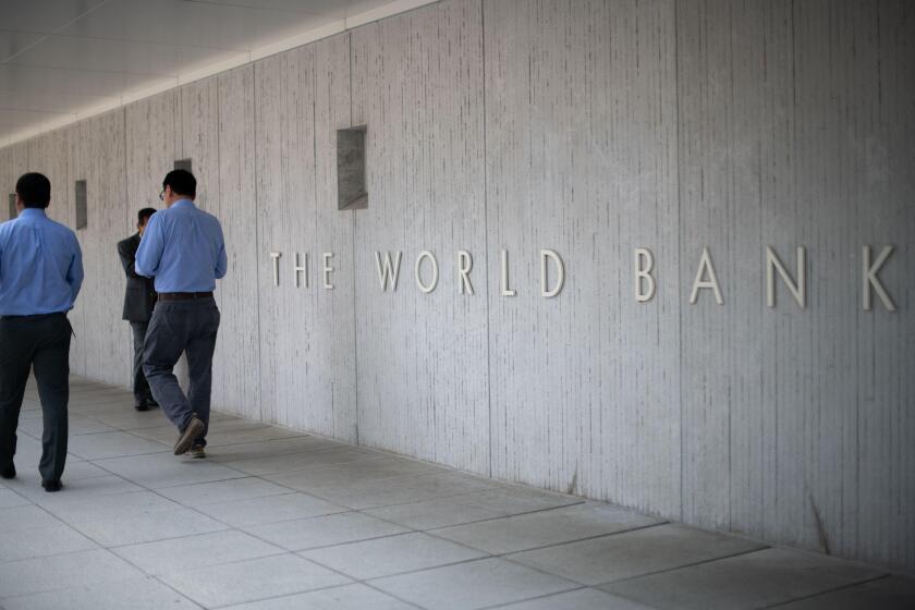 People walk by the World Bank headquarters in Washington, D.C., as seen on August 5, 2019. (Graeme Sloan/Sipa USA)