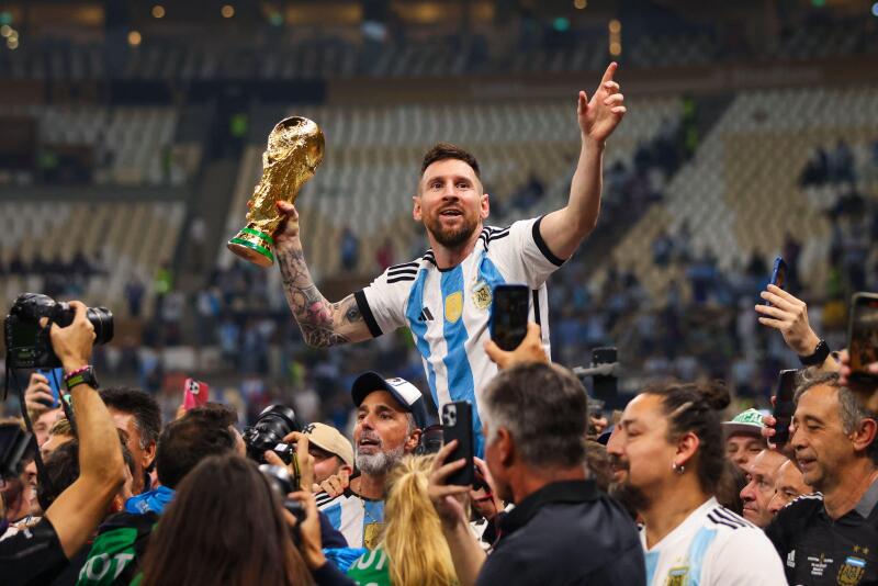 LUSAIL CITY, QATAR - DECEMBER 18: Lionel Messi celebrates with the World Cup Trophy after the FIFA World Cup Qatar 2022 Final match.