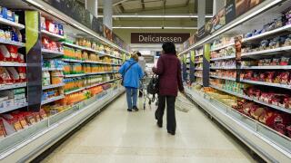 Shoppers at the aisle at Tesco supermarket food hall, UK