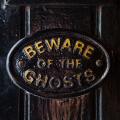 A Beware of the Ghosts plaque on the entrance to the Golden Fleece public house in York, England. It is regarded to be the most