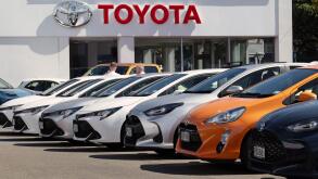 New Toyota vehicles displayed outside dealership showroom in Wellington, New Zealand.