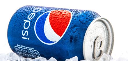 Can of Pepsi cola on a bed of ice and white background, Pepsi is a carbonated soft drink produce