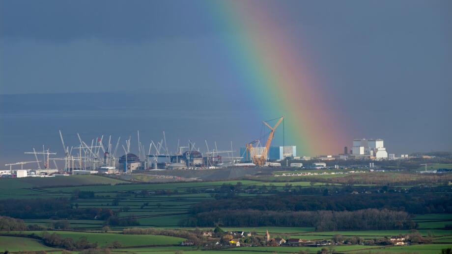 A strong rainbow seeming to emanate from the ?Hinkley C? construction site at Hinkley Point on the Bristol Channel coast, Somerset, England, UK.