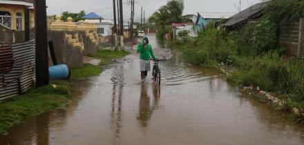 A man wades through a flooded street ahead of the forecasted arrival of Hurricane Melissa in Old Harbour, Jamaica, Monday, Oct. 27, 2025. (AP Photo/Matias Delacroix)