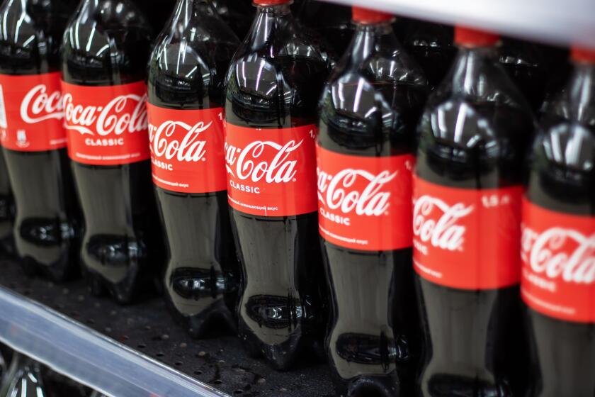 Belarus, Minsk - 30 april, 2024: A neat row of several CocaCola bottles is arranged on a shelf, showcasing the iconic drink. The display features seve