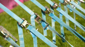 Row of tension tightening straps and pulleys on a large marquee