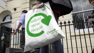 Not a plastic bag: "reduce reuse recycle" slogan on a cotton shopping bag.