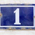 Number 1 (one) in white on a blue metal plate