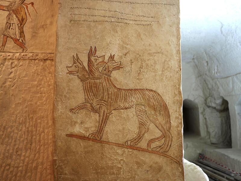 Mystical and ordinary animals on the wall in the family tomb in ancient city Maresha. Cerberus.