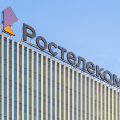 Close-up of signboard Rostelecom at the top of the building. 