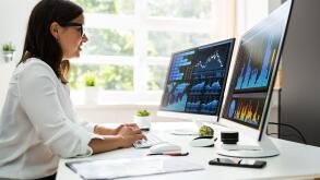 Analyst Women Looking At KPI Data On Computer Screen