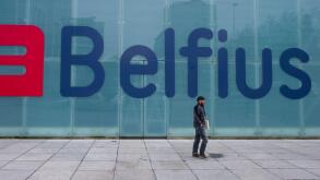 A man walks by the new logo and name for Belfius bank (formerly Dexia) in Brussels on Thursday, March 1, 2012. The bank unveiled its new name and logo on Thursday. (AP Photo/Geert Vanden Wijngaert)