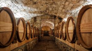 Wine cellar with row of wine barrels