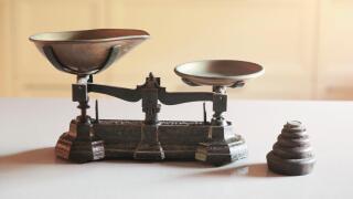 Old obsolete manual weighing scales and a pile of weights
