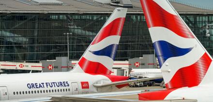 London, England, UK - 20 May 2025: Tail fins of British Airways jets in front of Terminal 5 at London Heathrow Airport