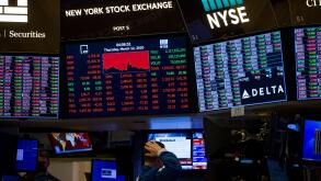New York, USA. 13th Mar, 2020. A trader works at the New York Stock Exchange (NYSE) in New York, the United States, March 12, 2020. Intensifying coronavirus fears battered Wall Street on Thursday with a historic nosedive in its worst session since the 198