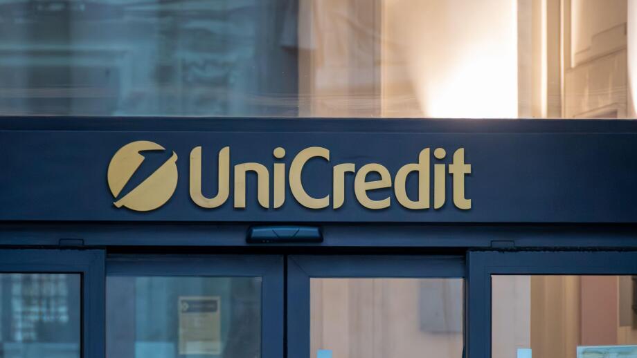 Sign and logo at the entrance of a branch of Unicredit, an Italian multinational banking group headquartered in Milan