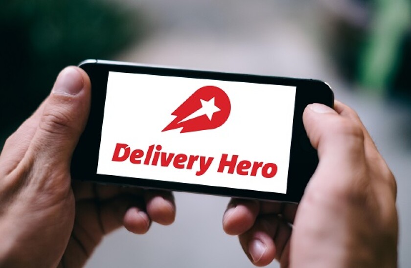 Closeup of iPhone screen with DELIVERY HERO APP LOGO and ICON on smartphone