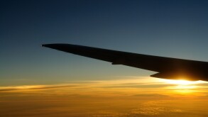 Sunset under airplane wing skyline