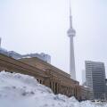 Winter storm view of downtown Toronto. Snow-covered cityscape.