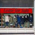 Lease for Sale banner sign in the window of a tailors shop in London.