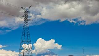 Power lines at Andes in Peru in front of an active volcano