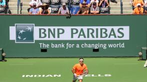 Indian Wells, California 20th March, 2015 Tennis player Roger Federer defeats Tomas Berdych in the Quarterfinal of the Men's Singles at the BNP Paribas Open (score 6-4 6-0). Photo: Larry Ellison in the brown shirt watches tennis player Roger Federer. Cred