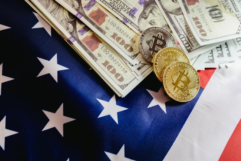 Bitcoin physical coins on American flag background with dollars 