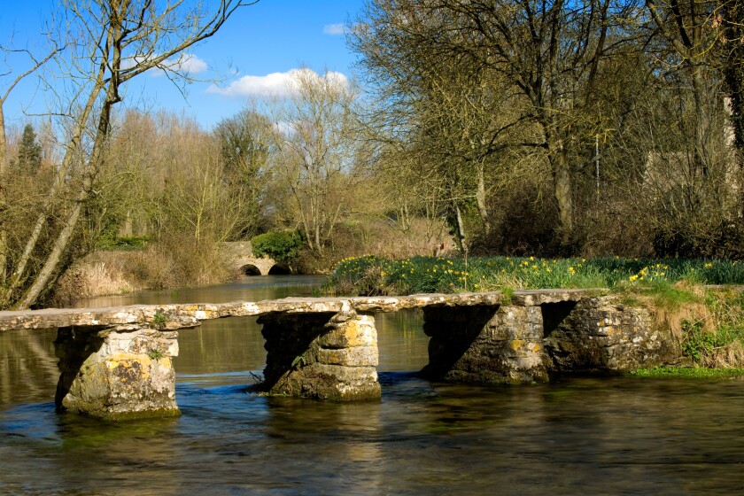 St.John's Bridge, a clapper bridge in Eastleach in Gloucestershire, Cotswolds, England, UK over the River Leach.. Image shot 03/2006. Exact date unknown.
