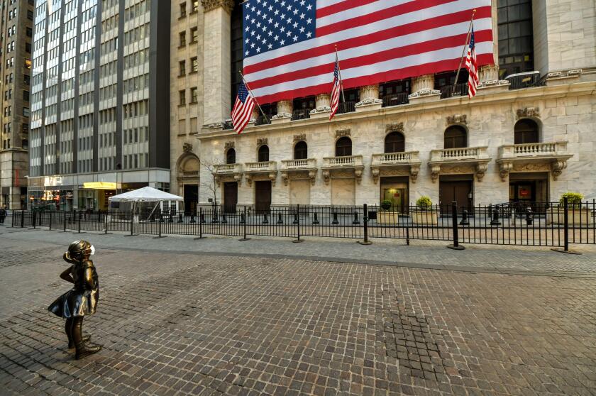 Fearless Girl with Mask on Wall Street in New York City on PAUSE during Coronavirus COVID-19 Pandemic