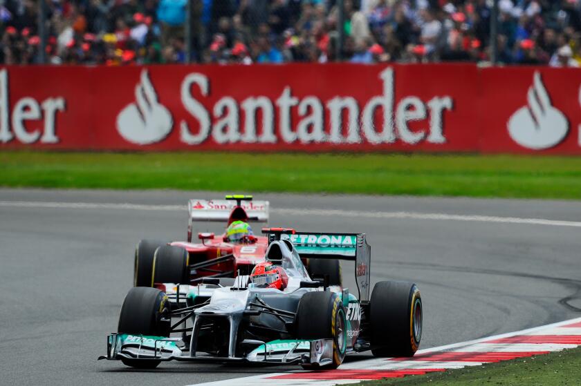 08.07.2012 Towcester, England. Michael Schumacher of Germany and Mercedes AMG Petronas F1 Team and Felipe Massa of Brazil and Scuderia Ferrari in action during the Race at the Santander British Grand Prix, Round 9 of the 2012 FIA Formula 1 World Champions