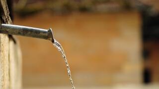 water well dropping from a water spender in a european city.