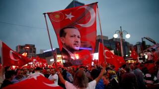 A supporter holds a flag depicting Turkish President Tayyip Erdogan during a pro-government demonstration in Ankara, Turkey, July 20, 2016. REUTERS/Baz Ratner/File Photo